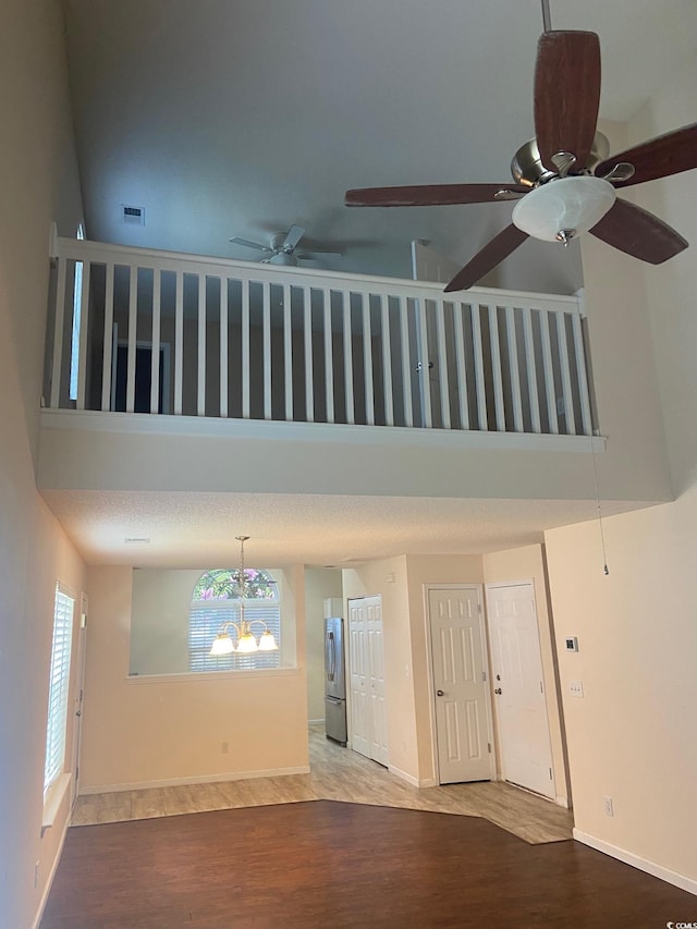 110 Palisade Loop Unit 110, Pawleys Island, SC 29585 - unfurnished room featuring a high ceiling, wood finished floors, a ceiling fan, and a chandelier