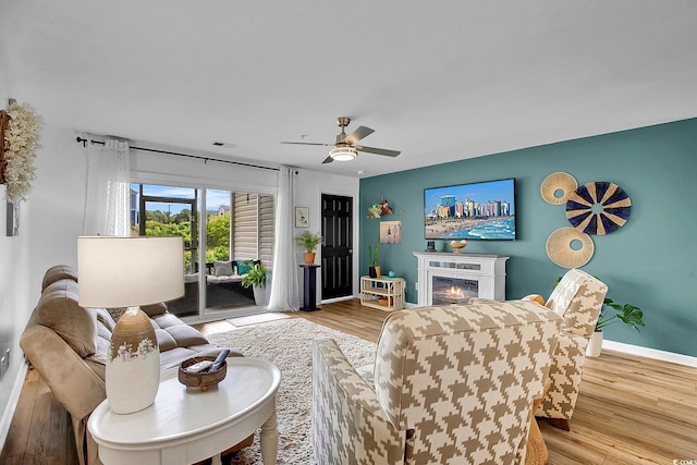 139 Butkus Dr Unit 3, Myrtle Beach, SC 29588 - living room with ceiling fan, a glass covered fireplace, and wood finished floors