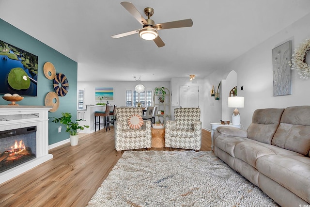 139 Butkus Dr Unit 3, Myrtle Beach, SC 29588 - living area featuring ceiling fan, light wood-style floors, and a warm lit fireplace