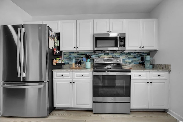 139 Butkus Dr Unit 3, Myrtle Beach, SC 29588 - kitchen featuring stainless steel appliances, white cabinets, and decorative backsplash