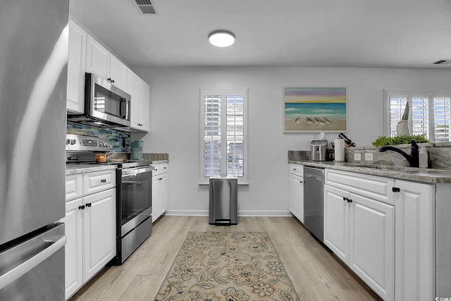 139 Butkus Dr Unit 3, Myrtle Beach, SC 29588 - kitchen with appliances with stainless steel finishes, healthy amount of natural light, and white cabinets