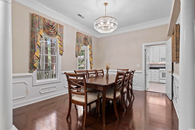 4495 Trotters Ct, Murrells Inlet, SC 29576 - dining space featuring a chandelier, crown molding, dark wood-style floors, and wainscoting