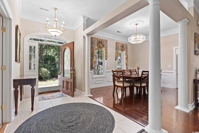 4495 Trotters Ct, Murrells Inlet, SC 29576 - foyer entrance featuring a chandelier, ornamental molding, light wood-style floors, decorative columns, and wainscoting