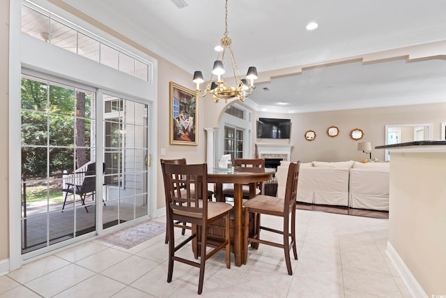 4495 Trotters Ct, Murrells Inlet, SC 29576 - dining area featuring crown molding, light tile patterned floors, a chandelier, a stone fireplace, and recessed lighting