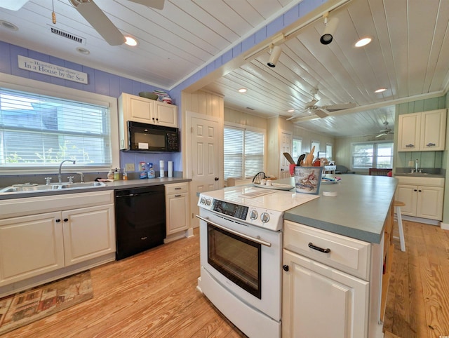 206 Atlantic Ave, Pawleys Island, SC 29585 - kitchen with ceiling fan, black appliances, light wood-style flooring, white cabinetry, and wooden ceiling