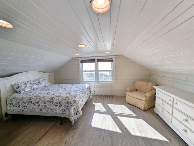206 Atlantic Ave, Pawleys Island, SC 29585 - bedroom with light wood-style floors, lofted ceiling, wood walls, and wooden ceiling