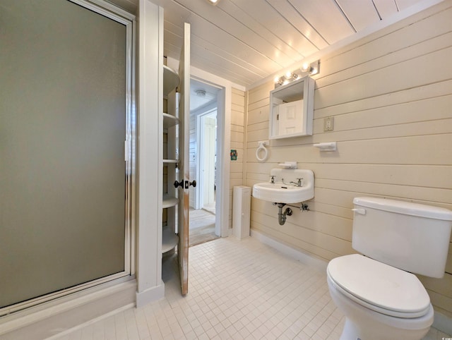 206 Atlantic Ave, Pawleys Island, SC 29585 - bathroom featuring tile patterned flooring, a stall shower, and wood walls