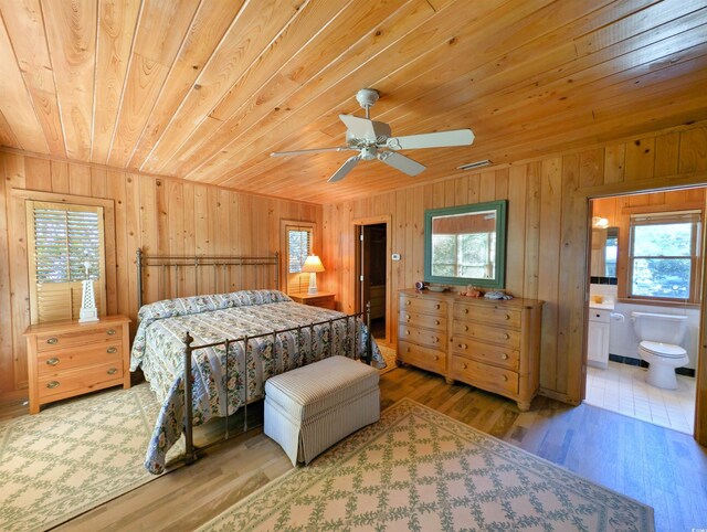 206 Atlantic Ave, Pawleys Island, SC 29585 - bedroom featuring wood ceiling, multiple windows, wood finished floors, wooden walls, and ensuite bathroom