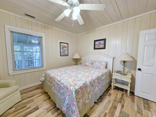 206 Atlantic Ave, Pawleys Island, SC 29585 - bedroom featuring light wood-style flooring, wood ceiling, crown molding, and a ceiling fan