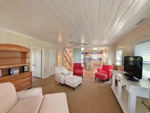 206 Atlantic Ave, Pawleys Island, SC 29585 - living room with light wood-style floors, stairs, and ceiling fan