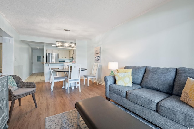 212 N 2nd Ave N Unit 162, North Myrtle Beach, SC 29582 - living room featuring light wood-type flooring, a textured ceiling, and crown molding
