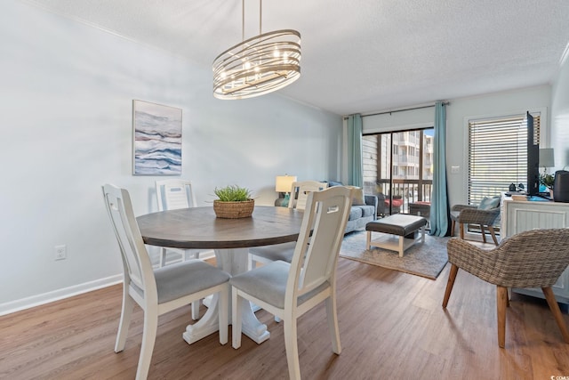 212 N 2nd Ave N Unit 162, North Myrtle Beach, SC 29582 - dining area with light wood-style flooring, a chandelier, and a textured ceiling