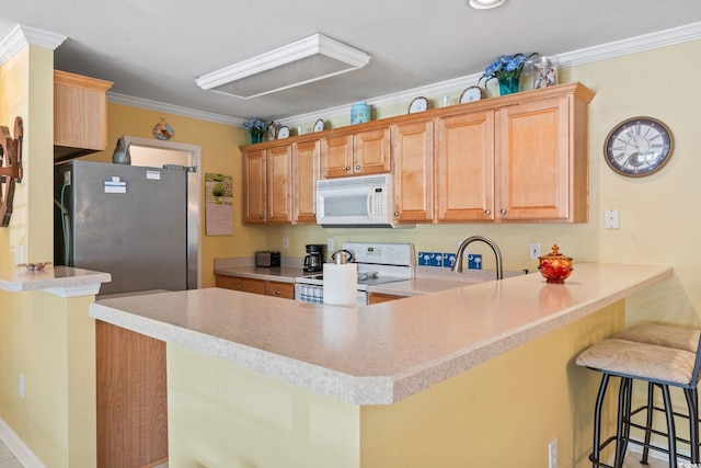 4654 Fringetree Dr Unit 7B, Murrells Inlet, SC 29576 - kitchen with white appliances, a peninsula, a breakfast bar, crown molding, and light countertops