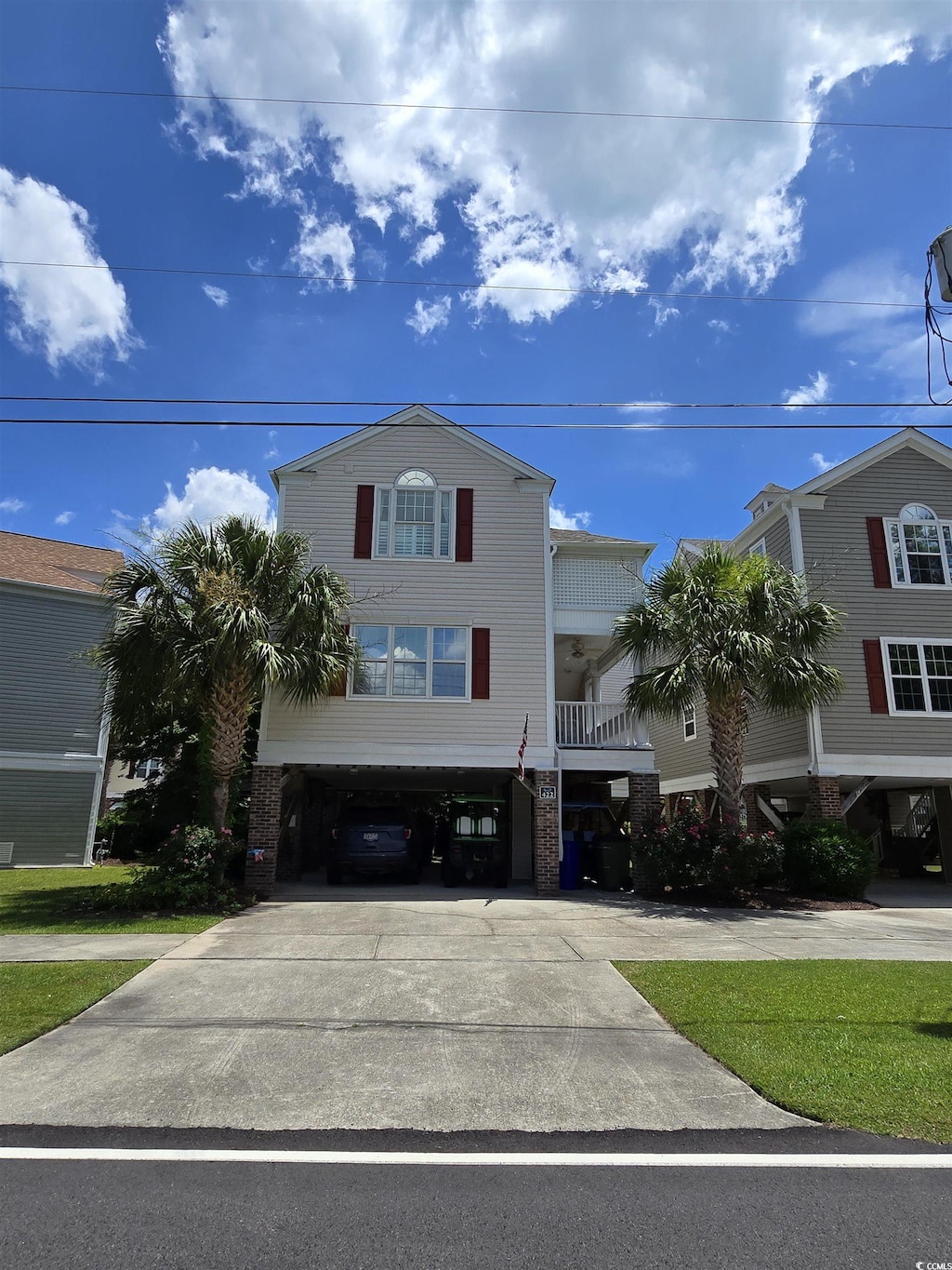 422 S 3rd Ave, Surfside Beach, SC 29575 - coastal inspired home featuring a carport and driveway