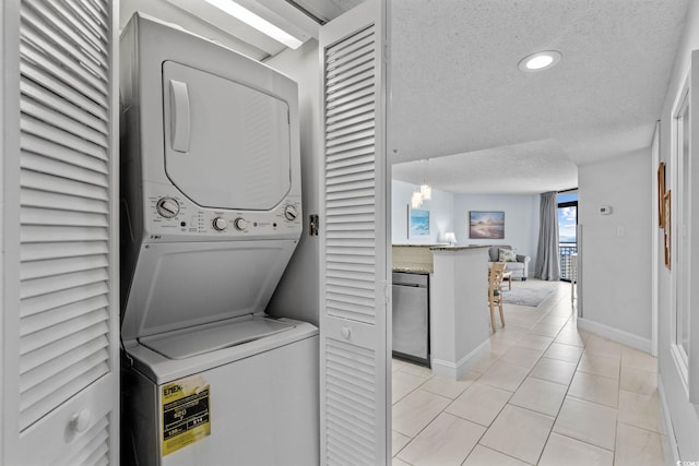 205 74th Ave N Unit 1809, Myrtle Beach, SC 29572 - laundry room with stacked washer and clothes dryer, a textured ceiling, light tile patterned floors, and recessed lighting