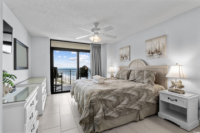 205 74th Ave N Unit 1809, Myrtle Beach, SC 29572 - bedroom with access to exterior, a textured ceiling, ceiling fan, and light tile patterned floors