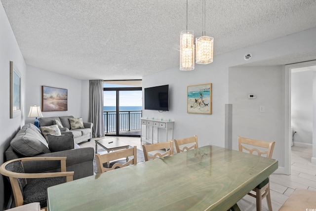 205 74th Ave N Unit 1809, Myrtle Beach, SC 29572 - dining space featuring a textured ceiling, floor to ceiling windows, and a chandelier