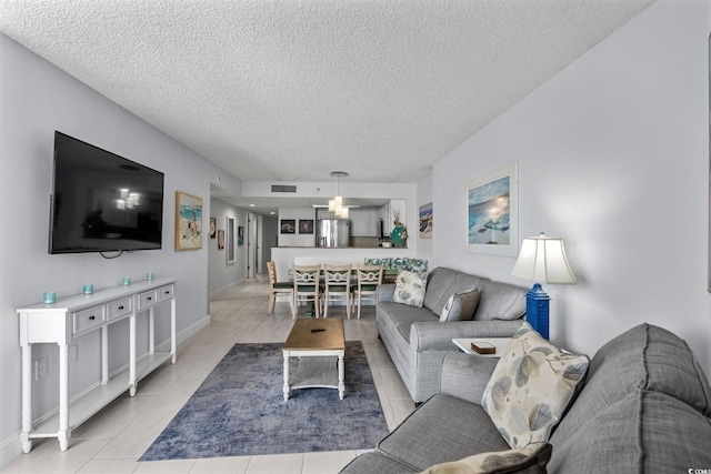 205 74th Ave N Unit 1809, Myrtle Beach, SC 29572 - living area featuring a textured ceiling and light tile patterned flooring