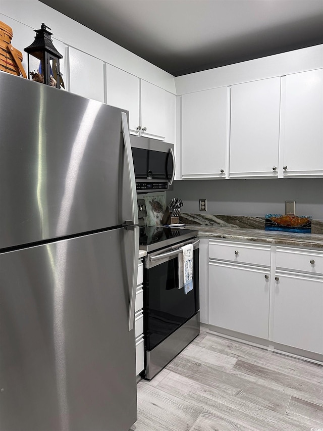 435 Ocean Creek Dr Unit 2731, Myrtle Beach, SC 29572 - kitchen with stainless steel appliances, white cabinets, and light wood finished floors