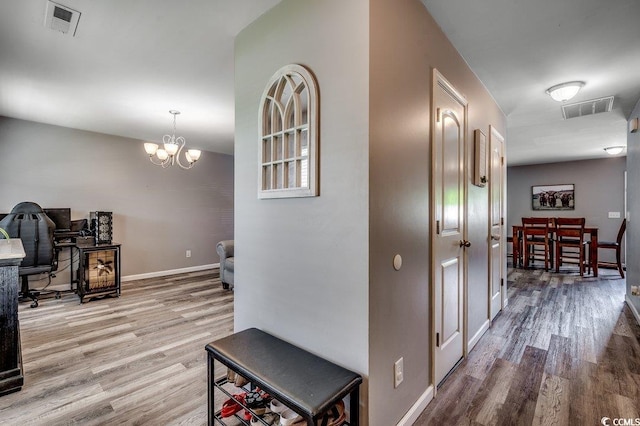 780 Trap Shooter Cir, Longs, SC 29568 - hallway with wood finished floors and a chandelier