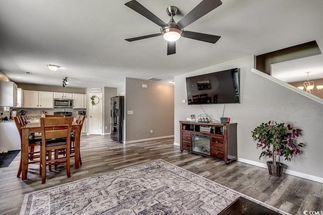 780 Trap Shooter Cir, Longs, SC 29568 - living area with dark wood-style floors, ceiling fan, and a chandelier