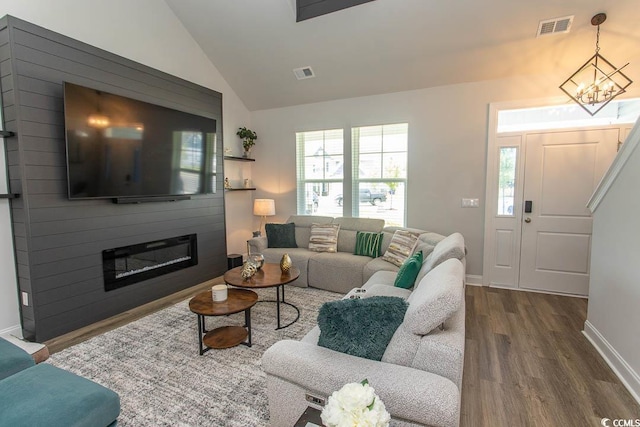 2429 Campton Loop, Conway, SC 29527 - living area with dark wood-type flooring, lofted ceiling, a chandelier, and a large fireplace