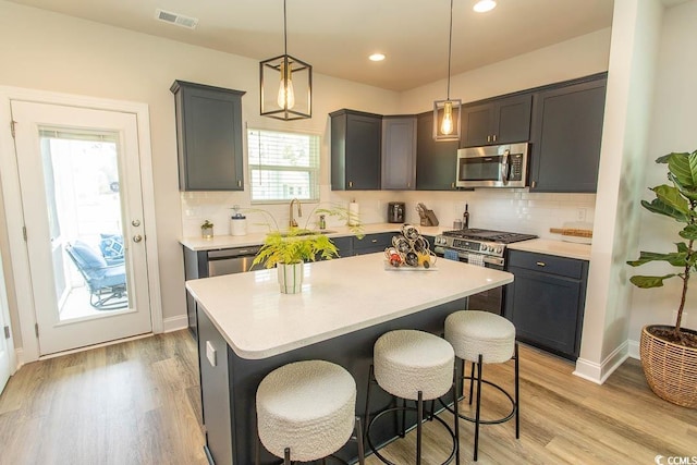 2429 Campton Loop, Conway, SC 29527 - kitchen featuring stainless steel appliances, light countertops, light wood-type flooring, a kitchen breakfast bar, and recessed lighting
