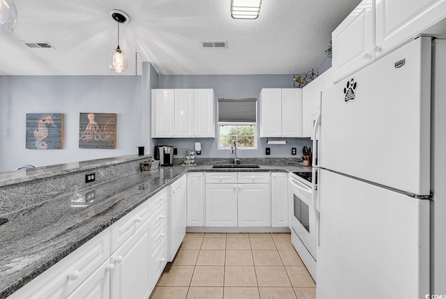 7977 Leeward Ln, Murrells Inlet, SC 29576 - kitchen with white appliances, a textured ceiling, white cabinets, dark stone countertops, and hanging light fixtures