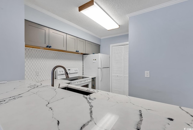 4350 Intracoastal Dr Unit 1403, Little River, SC 29566 - kitchen featuring white appliances, gray cabinetry, a textured ceiling, light stone counters, and ornamental molding