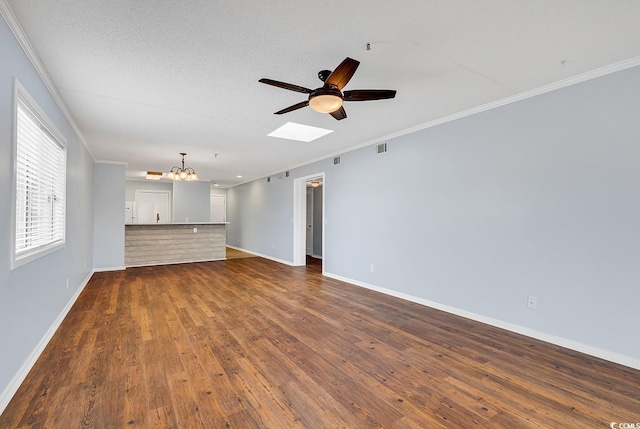 4350 Intracoastal Dr Unit 1403, Little River, SC 29566 - unfurnished living room with ornamental molding, a ceiling fan, dark wood-type flooring, a chandelier, and a skylight