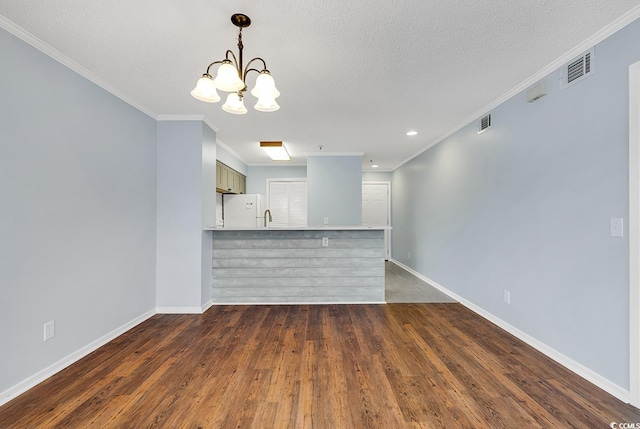 4350 Intracoastal Dr Unit 1403, Little River, SC 29566 - kitchen with freestanding refrigerator, a peninsula, crown molding, a chandelier, and dark wood-style flooring