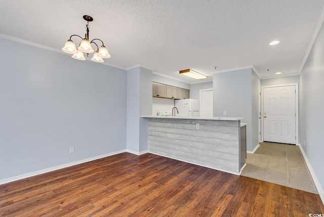 4350 Intracoastal Dr Unit 1403, Little River, SC 29566 - kitchen featuring freestanding refrigerator, gray cabinets, crown molding, light countertops, and recessed lighting