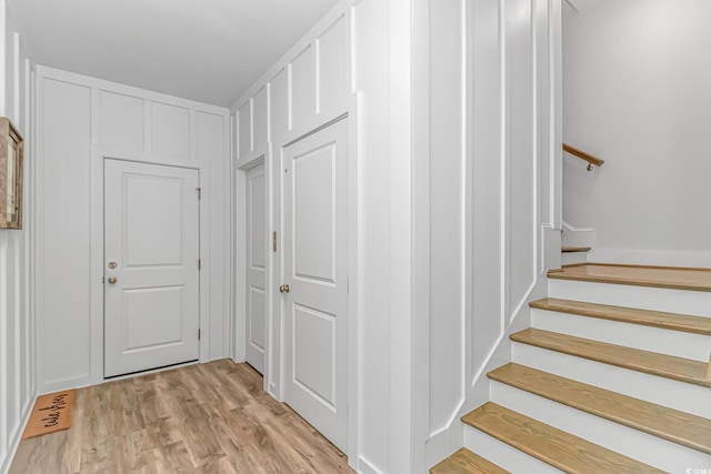 143 Enclave Pl, Pawleys Island, SC 29585 - hallway featuring light wood-style flooring and stairs