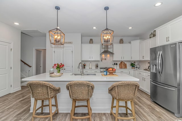 143 Enclave Pl, Pawleys Island, SC 29585 - kitchen featuring stainless steel refrigerator with ice dispenser, white cabinets, light countertops, light wood-style flooring, and recessed lighting