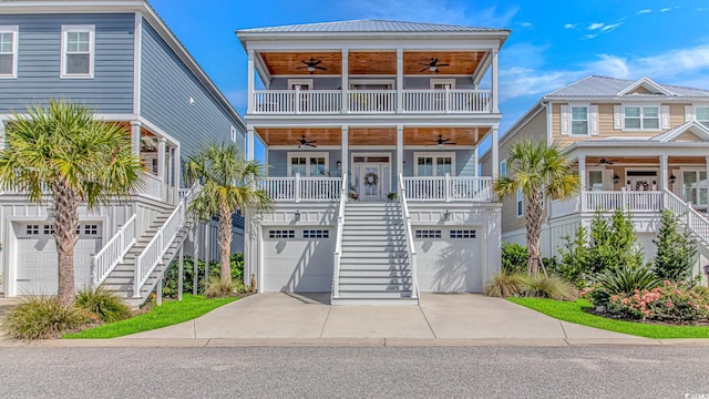 143 Enclave Pl, Pawleys Island, SC 29585 - coastal inspired home with a ceiling fan, stairway, a garage, and concrete driveway