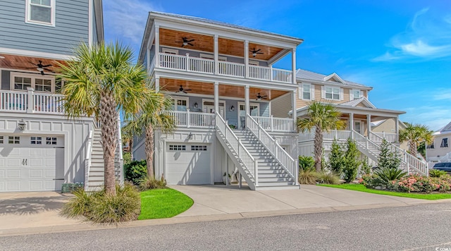 143 Enclave Pl, Pawleys Island, SC 29585 - coastal home with a ceiling fan, stairs, a garage, and covered porch