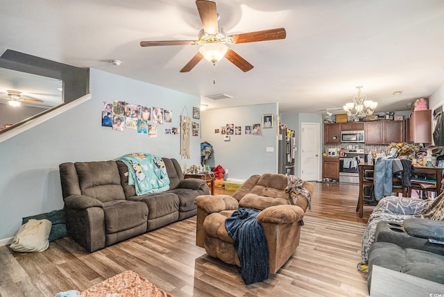 912 Clay Pigeon Ct, Longs, SC 29568 - living area with a ceiling fan, a chandelier, and light wood-style flooring