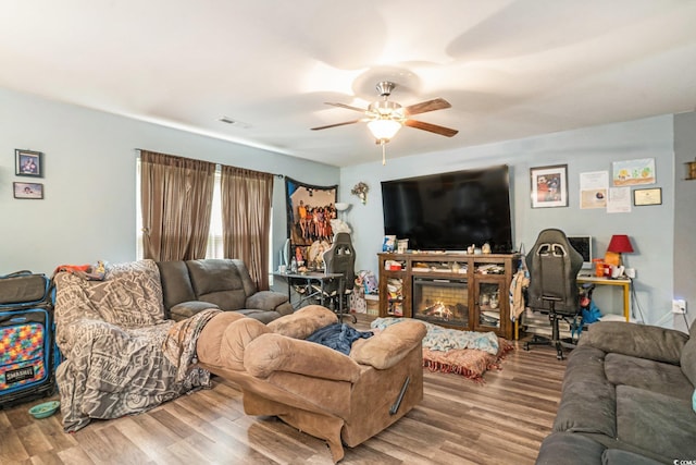 912 Clay Pigeon Ct, Longs, SC 29568 - living area featuring wood finished floors, ceiling fan, and a warm lit fireplace