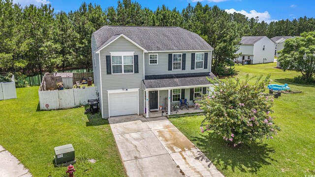 912 Clay Pigeon Ct, Longs, SC 29568 - traditional-style house with covered porch, concrete driveway, an attached garage, and roof with shingles