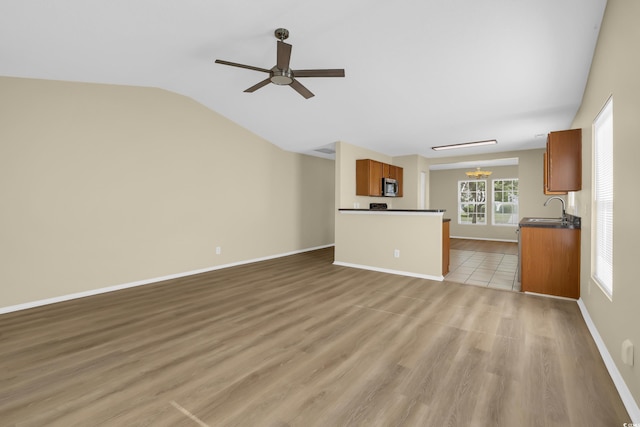 428 Bellegrove Dr, Myrtle Beach, SC 29577 - unfurnished living room featuring ceiling fan, wood finished floors, vaulted ceiling, and a chandelier