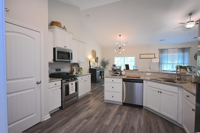 523 Charlton Blvd, Georgetown, SC 29440 - kitchen featuring appliances with stainless steel finishes, dark wood finished floors, ceiling fan, white cabinetry, and light stone counters