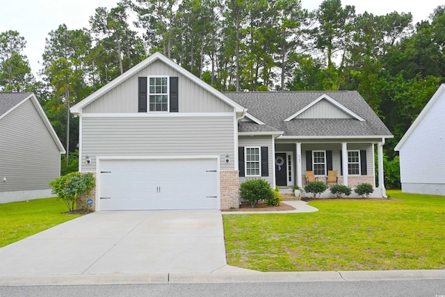 523 Charlton Blvd, Georgetown, SC 29440 - view of front facade with covered porch, a garage, a front lawn, and driveway