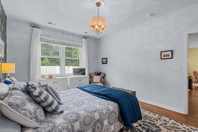 208 Forestbrook Cove Cir, Myrtle Beach, SC 29588 - bedroom featuring wood finished floors and a chandelier
