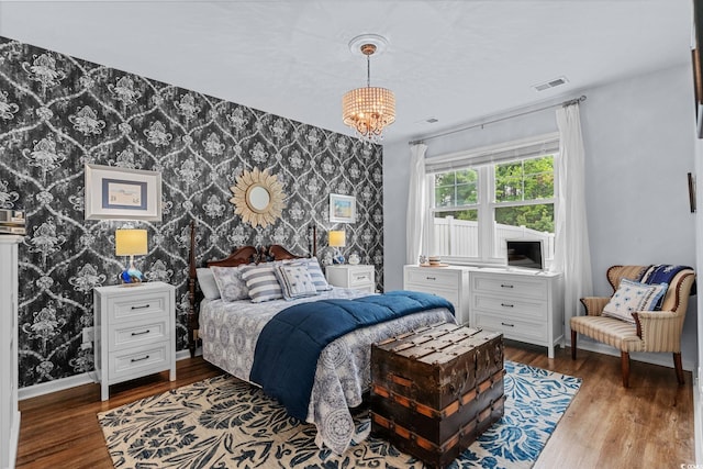 208 Forestbrook Cove Cir, Myrtle Beach, SC 29588 - bedroom featuring an accent wall, wallpapered walls, wood finished floors, and a chandelier