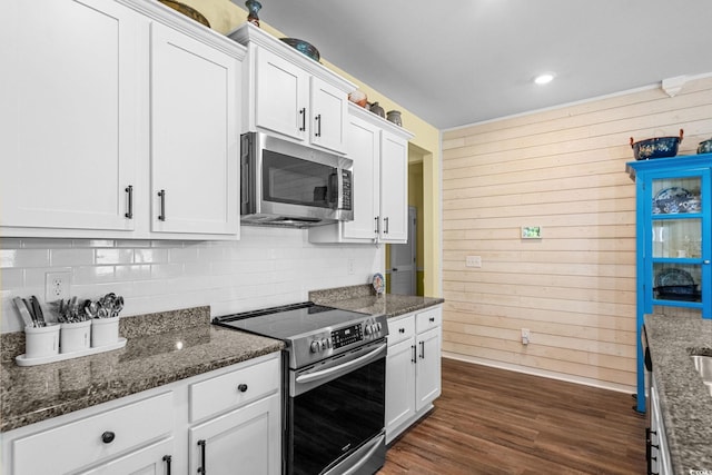 208 Forestbrook Cove Cir, Myrtle Beach, SC 29588 - kitchen with appliances with stainless steel finishes, wood walls, backsplash, white cabinets, and recessed lighting