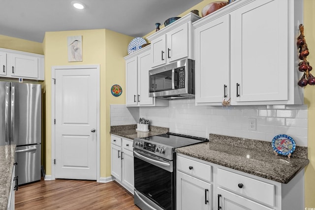 208 Forestbrook Cove Cir, Myrtle Beach, SC 29588 - kitchen featuring stainless steel appliances, white cabinets, wood finished floors, backsplash, and dark stone countertops