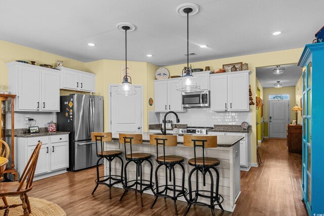 208 Forestbrook Cove Cir, Myrtle Beach, SC 29588 - kitchen with stainless steel appliances, tasteful backsplash, dark wood-style flooring, white cabinetry, and recessed lighting