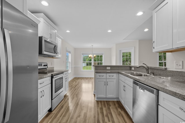 104 Fox Trot Dr, Galivants Ferry, SC 29544 - kitchen featuring appliances with stainless steel finishes, light wood finished floors, white cabinets, a peninsula, and recessed lighting