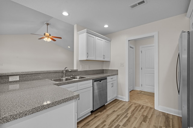 104 Fox Trot Dr, Galivants Ferry, SC 29544 - kitchen with stainless steel appliances, a ceiling fan, white cabinets, lofted ceiling, and light wood-type flooring