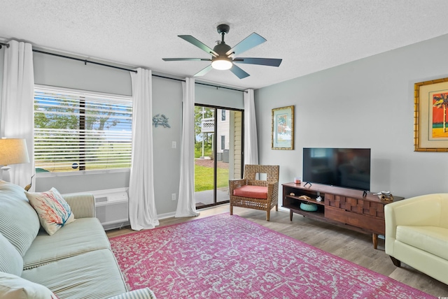 1100 Possum Trot Rd Unit G117, North Myrtle Beach, SC 29582 - living room with a ceiling fan, a textured ceiling, and wood finished floors